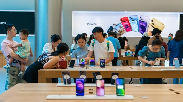 Customers try iPhones at an Apple store