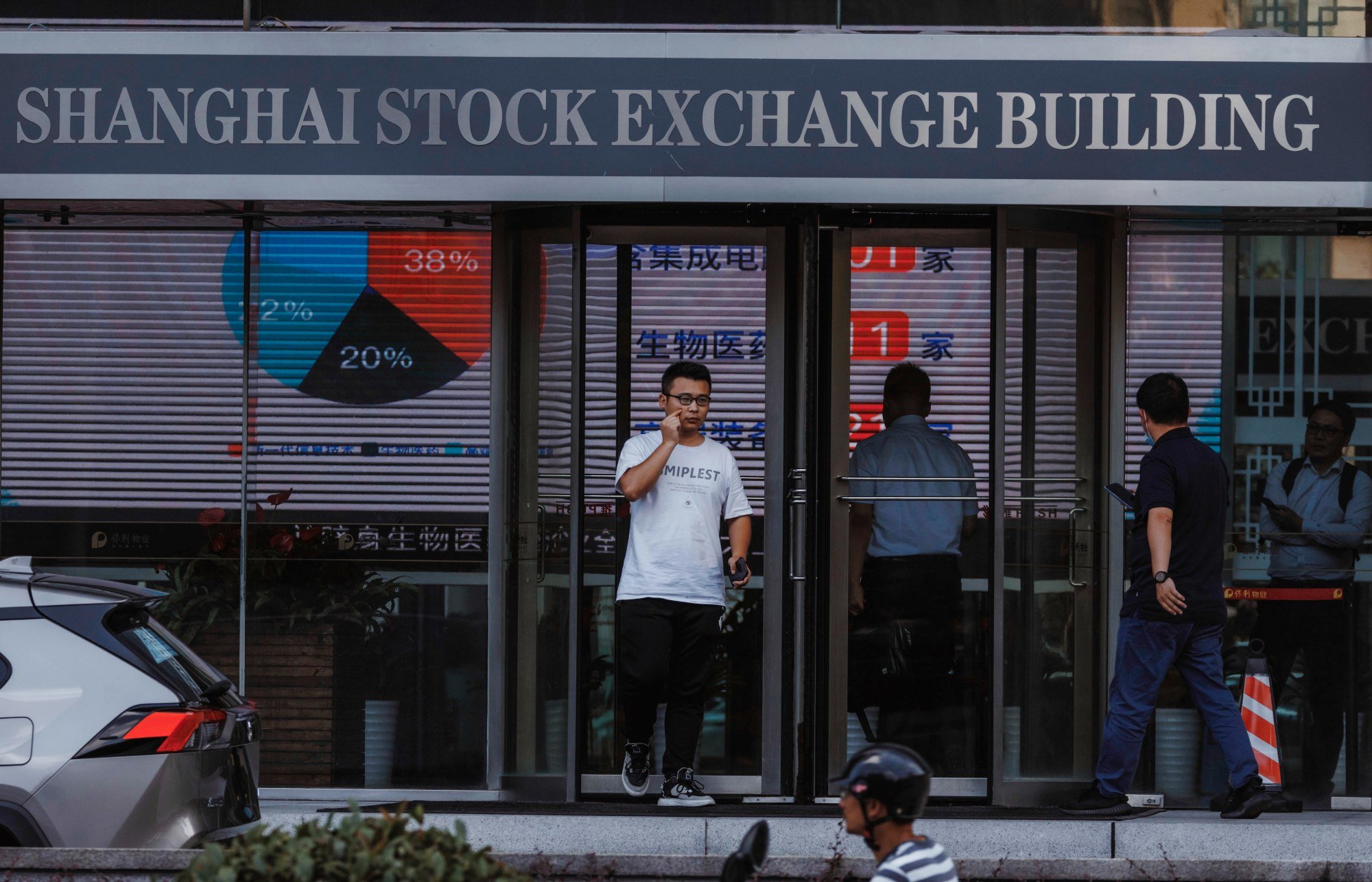 People walk past the Shanghai Stock Exchange building in Shanghai, on August 21, 2023. China’s exchanges lead the world’s IPO venues in terms of fundraising in 2023. Photo: EPA-EFE