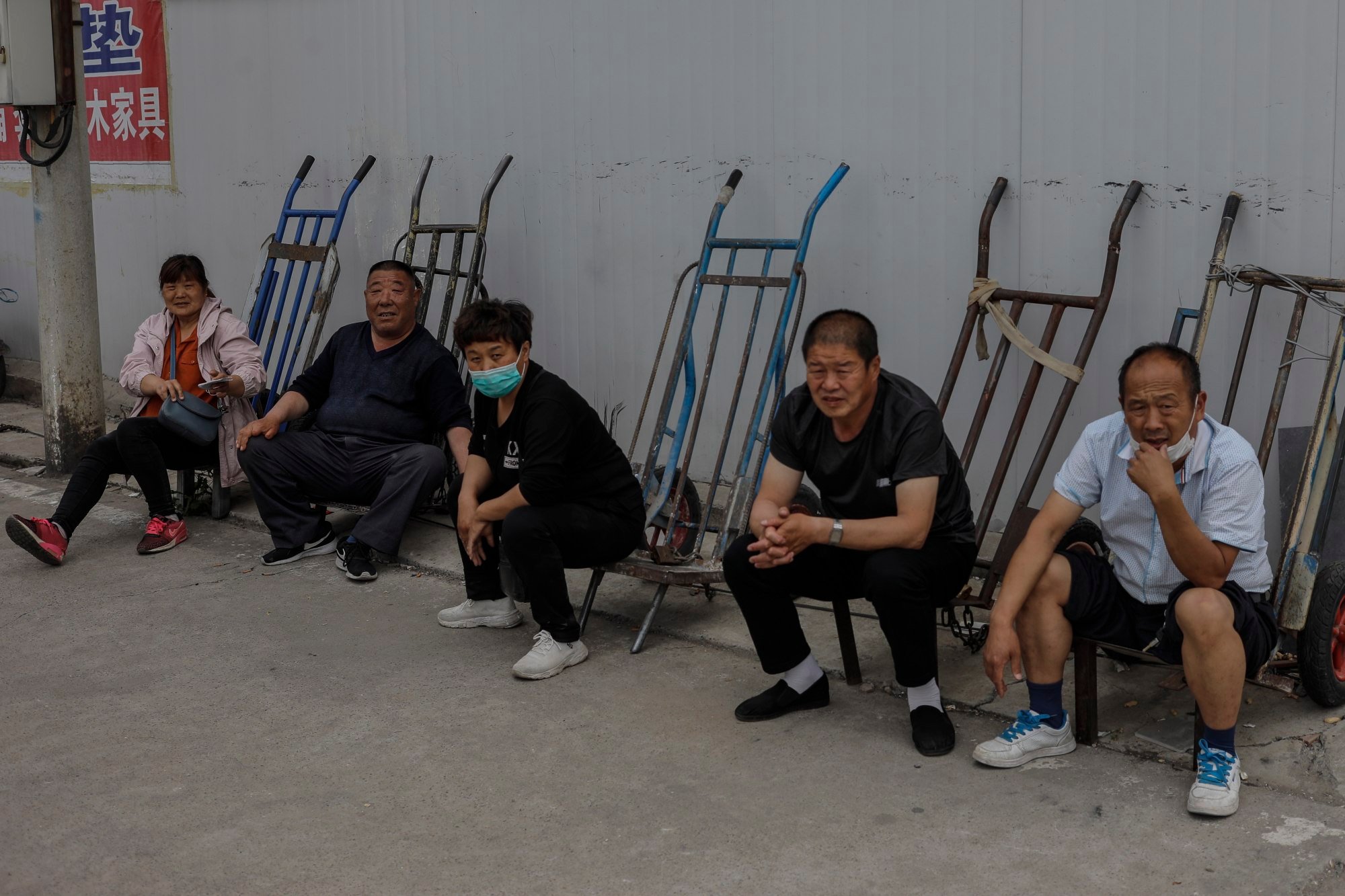 Migrant workers wait to be called up in Beijing. Photo: EPA-EFE