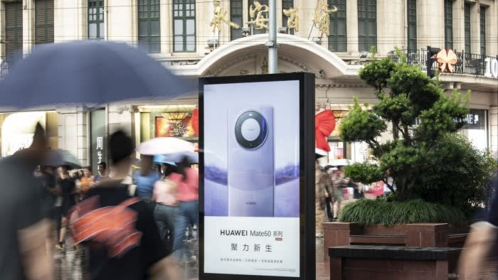 An advertisement for the Huawei Mate 60 series smartphone in a Shanghai street