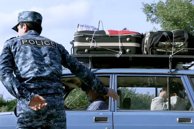 A vehicle carrying refugees arrives at a registration centre in Armenia