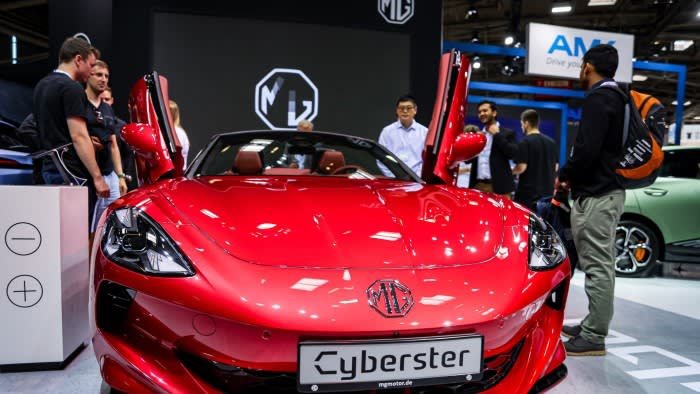 Visitors look at a Cyberster electric car by Chinese car brand MG.