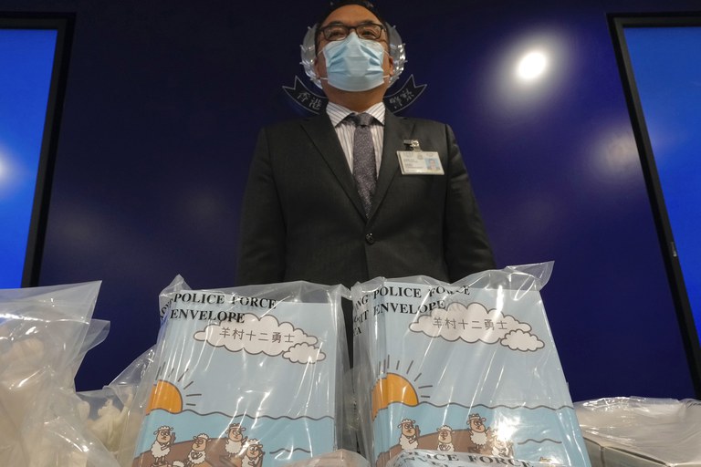 ENG_CHN_SeditiousSheep_09132023_02.jpg Li Kwai-wah, senior superintendent of Police National Security Department, poses with banned children's books on stories that revolve around a village of sheep which has to deal with wolves from a different village in Hong Kong, July 22, 2021. Authorities in Hong Kong have charged a man with "possession of seditious publications" after he bought copies of the banned "Sheep Village" series of children's picture books from the United Kingdom. Credit: Vincent Yu/AP