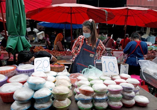 ENG_BUR_OverseasHoldings_09122023.3.jpg Migrant workers from Myanmar work at a street market in Bangkok, Thailand, in 2020. Credit: Soe Zeya Tun/Reuters