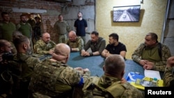 Ukrainian President Volodymyr Zelenskyy attends a meeting with commanders of Ukrainian Armed Forces brigades as he visits a frontline in Donetsk region, Sept. 4, 2023. (Ukrainian Presidential Press Service/Handout via Reuters)