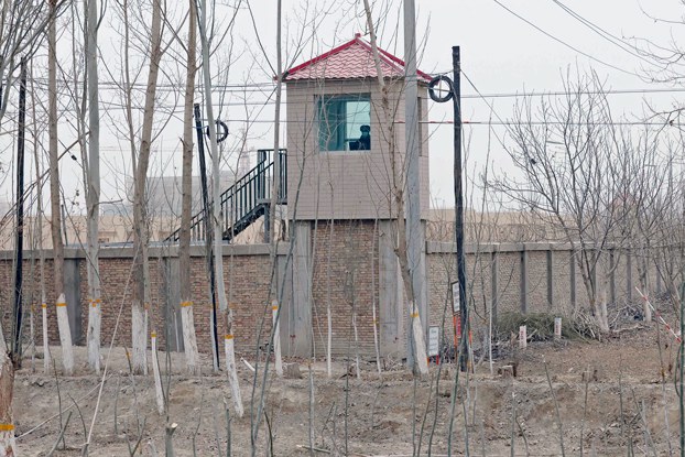 ENG_UYG_BusinessmanSentenced_09132023_02.jpg A security guard watches from a tower at a detention facility in Yarkent County in northwestern China's Xinjiang Uyghur Autonomous Region, March 21, 2021. Credit: Ng Han Guan/AP