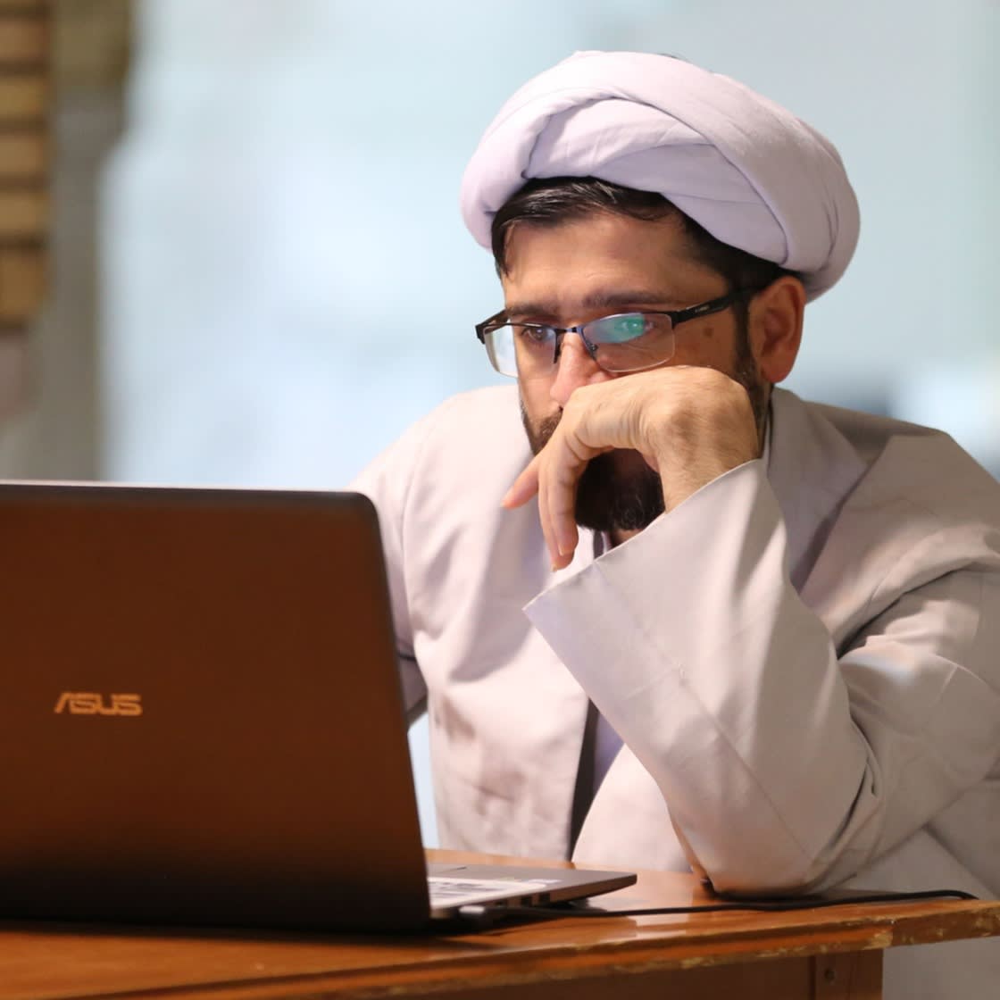 A Muslim Shiite cleric studes at the Imam Khomeini Education and Research Institute in the holy city of Qom