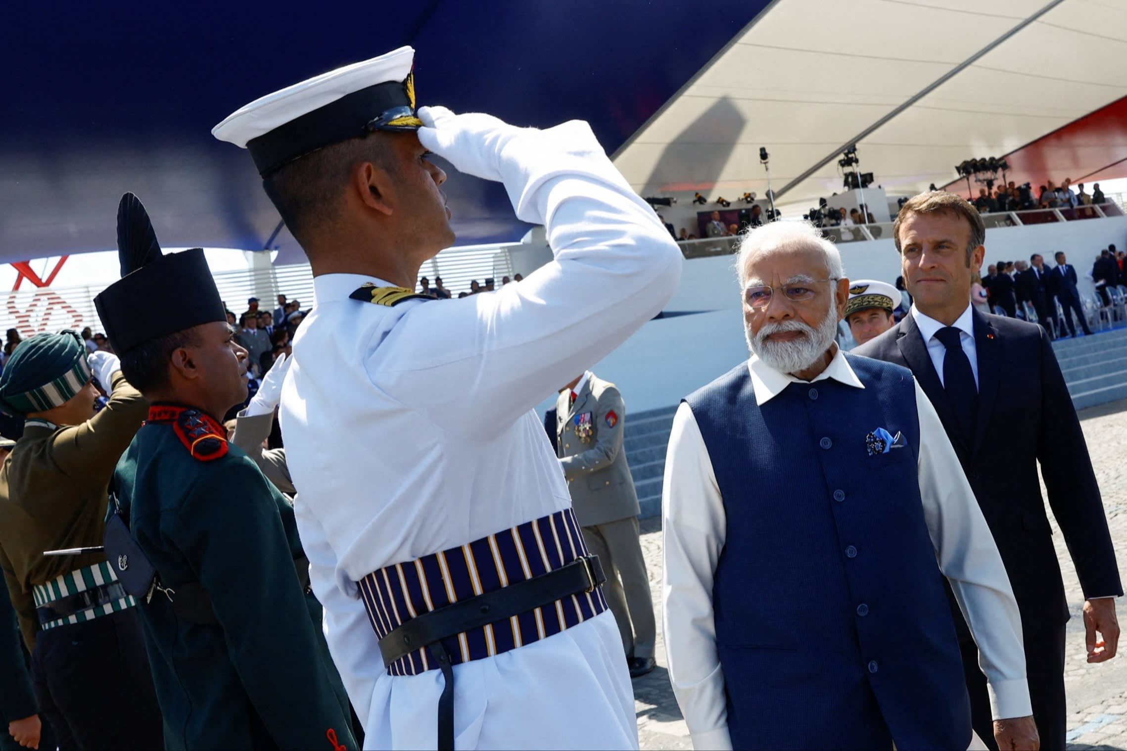 Narendra Modi and Emmanuel Macronon Bastille Day in Paris with assembled military