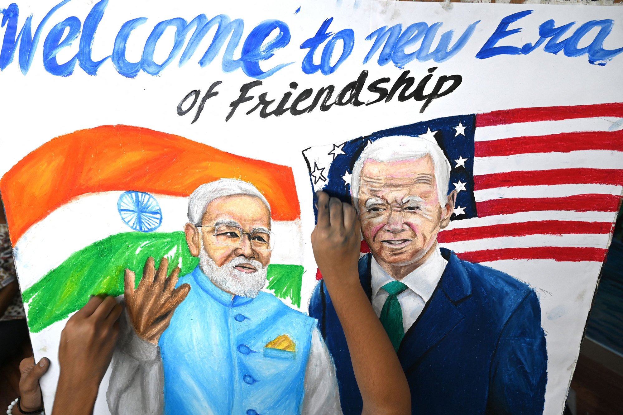Students give final touches to a painting of Modi and US President Joe Biden, at an art school in Mumbai. Photo: AFP/Getty Images/TNS