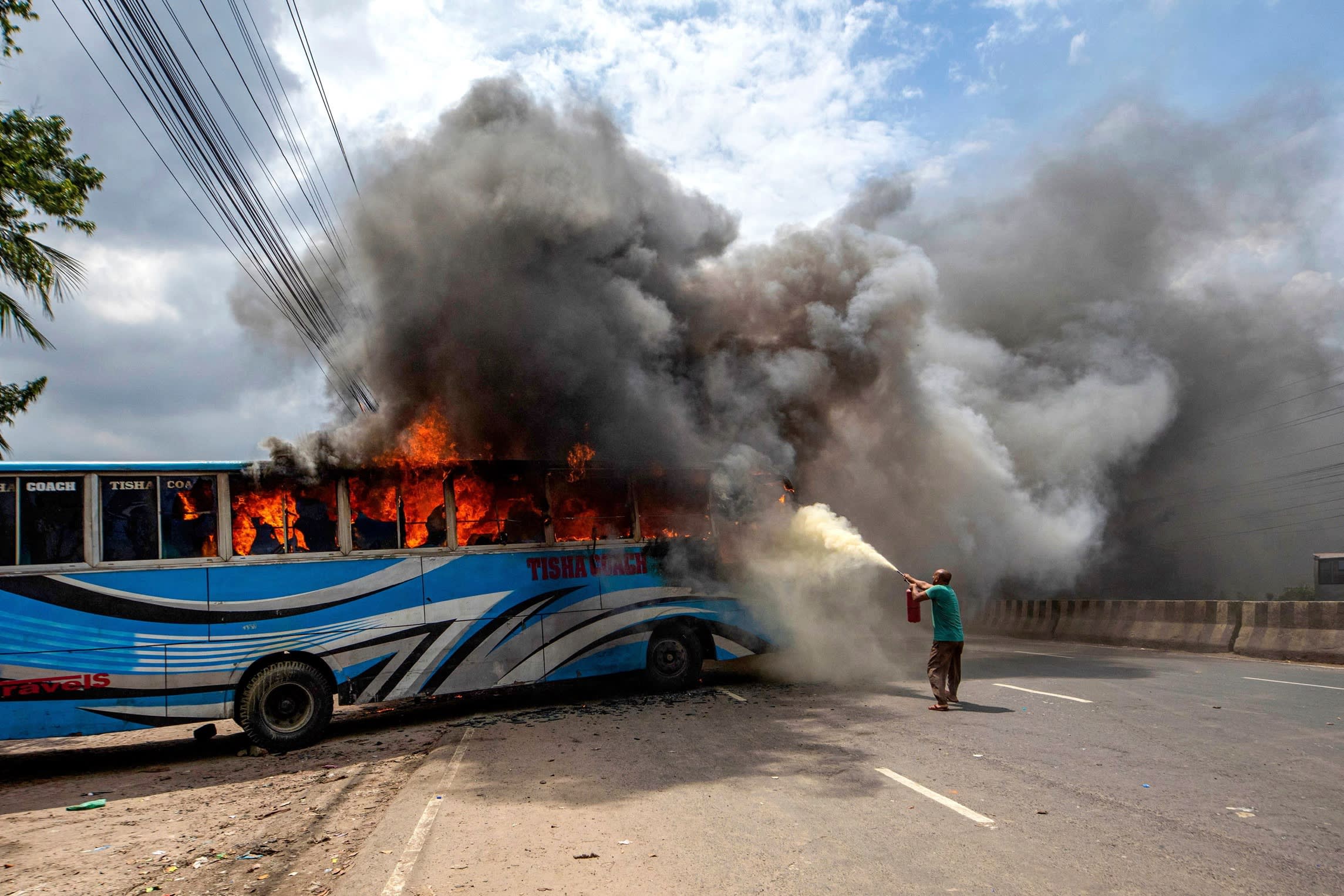 Bangladesh Nationalist party activists set a bus, blocking a highway in Dhaka in July, to demand Sheikh Hasina’s resignation