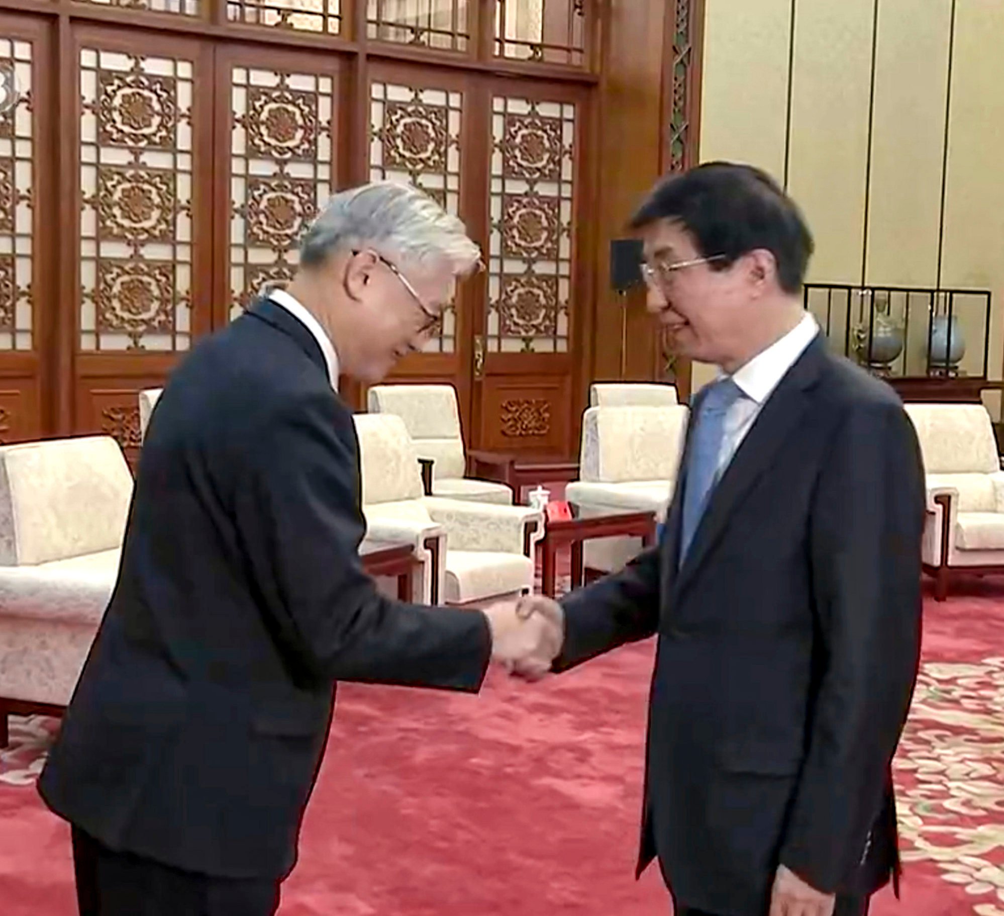 Andrew Hsia (left) meets Wang Huning, a member of the Politburo Standing Committee, in Beijing in February. Photo: CCTV