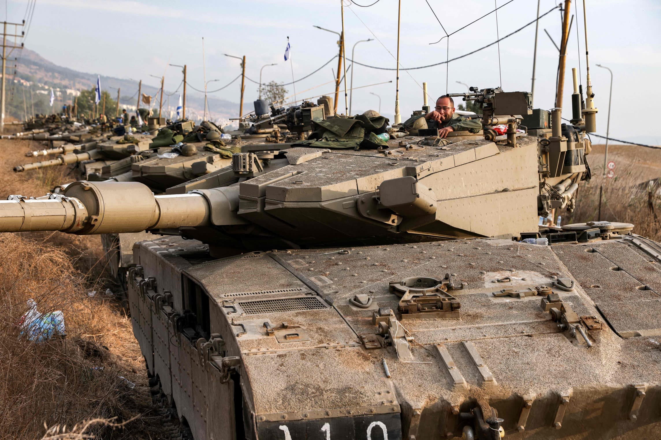 A Merkava battle tank in an armoured column amassed in northern Israel near the border with Lebanon