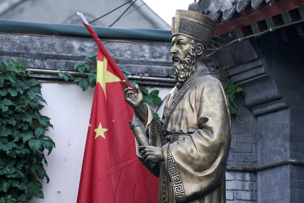 ENG_CHN_PatrioticEducation_10202023.3.jpg A Chinese flag is seen next to a statue at the entrance of Beijing South Catholic Church, a government-sanctioned Catholic church, in Beijing, Sept. 29, 2018. Credit: Jason Lee/Reuters