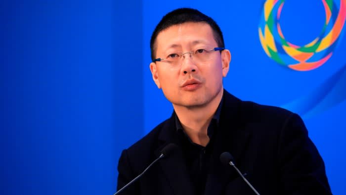 Neil Shen speaking into two microphones