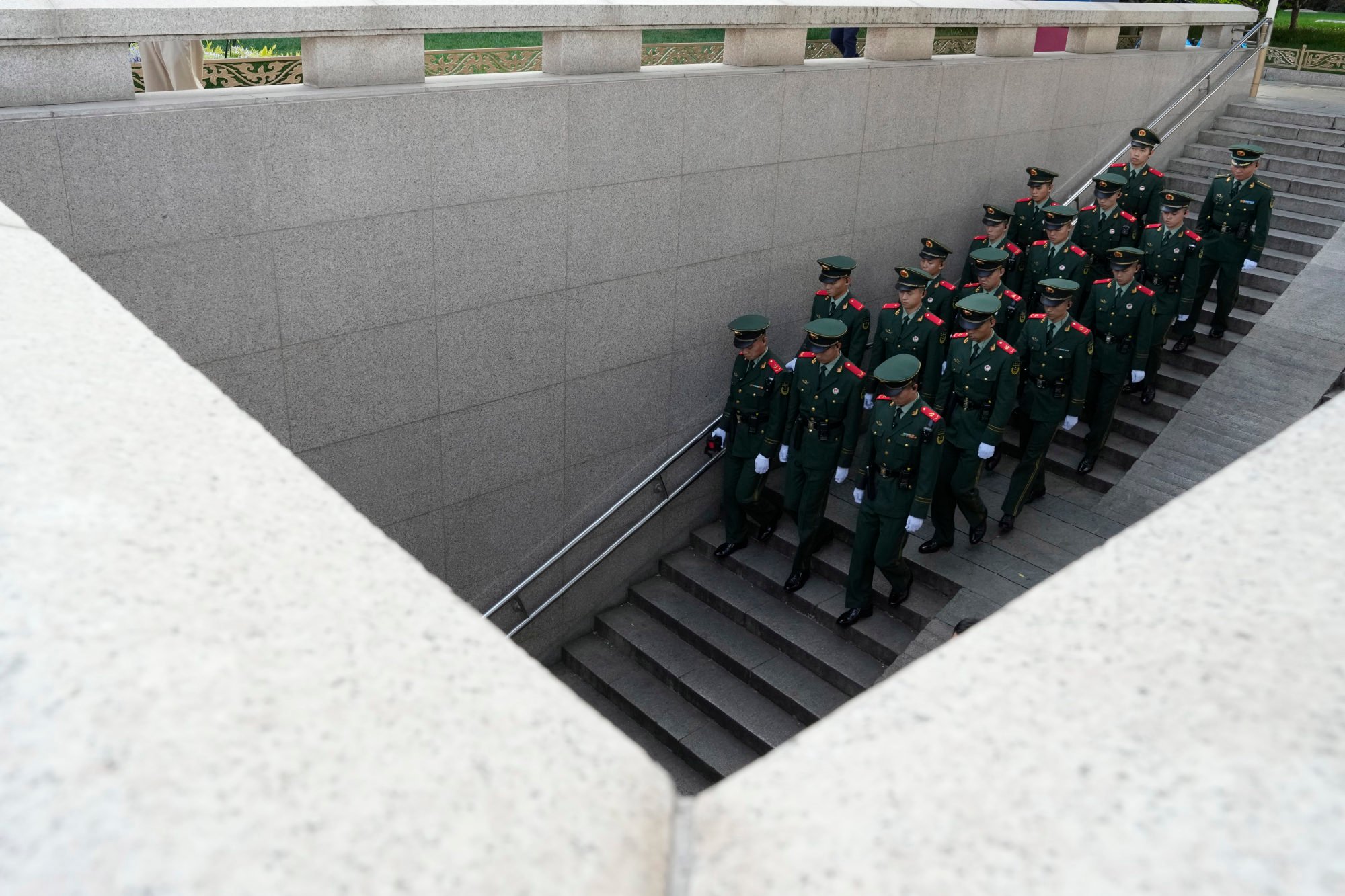 Chinese paramilitary policemen march down to an underpass as security is tighten ahead of the Belt and Road Forum in Beijing. Photo: AP