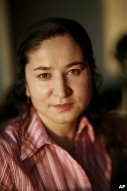 FILE - Rahile Dawut poses for a photo in Urumqi, the capital of China's far west Xinjiang region, in August 2006, in this handout photo released by Lisa Ross.