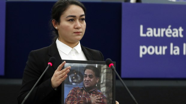 fd181b4d-1f51-47f0-b545-c00eac7da2d8.jpg Jewher Ilham holds a photo of her father, Ilham Tohti, during the Sakharov Prize ceremony at the European Parliament, in Strasbourg, France, Dec. 18, 2019. Credit: AP Photo