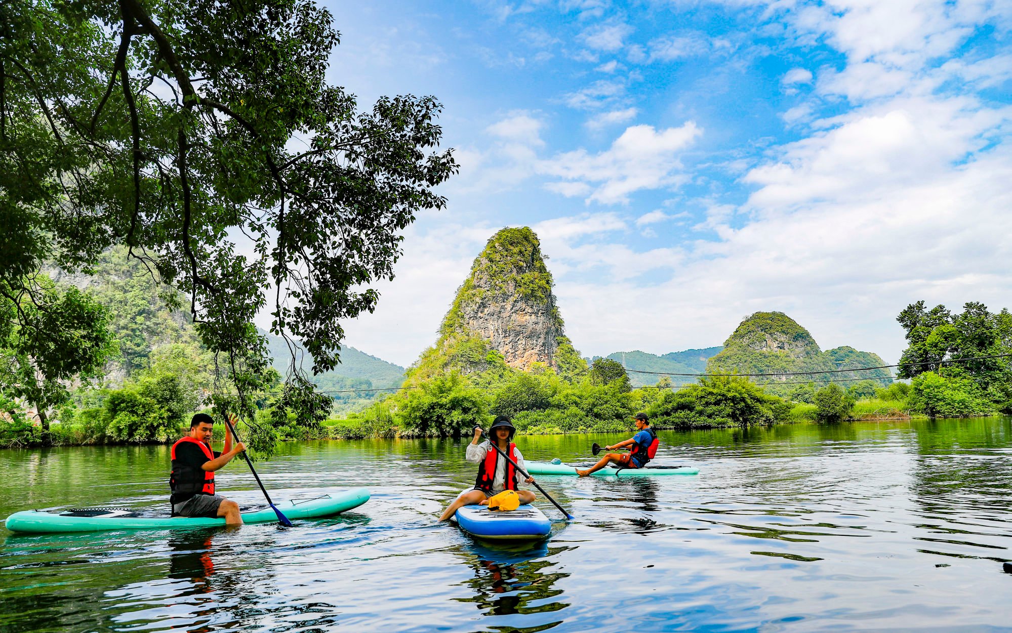 Tourists paddle on a river in Guilin, southern China. But the slow recovery of the tourism sector has seen it having to rely largely on domestic travellers with many foreigners staying away. Photo: Xinhua