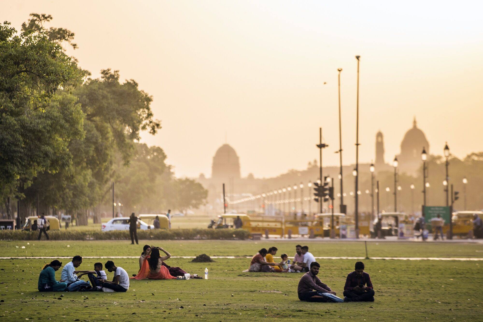 People sit on the grass at Kartavya Path in the early evening in New Delhi, India, on April 18. As India’s population booms, its GDP is forecast to expand dramatically. Photo: Bloomberg
