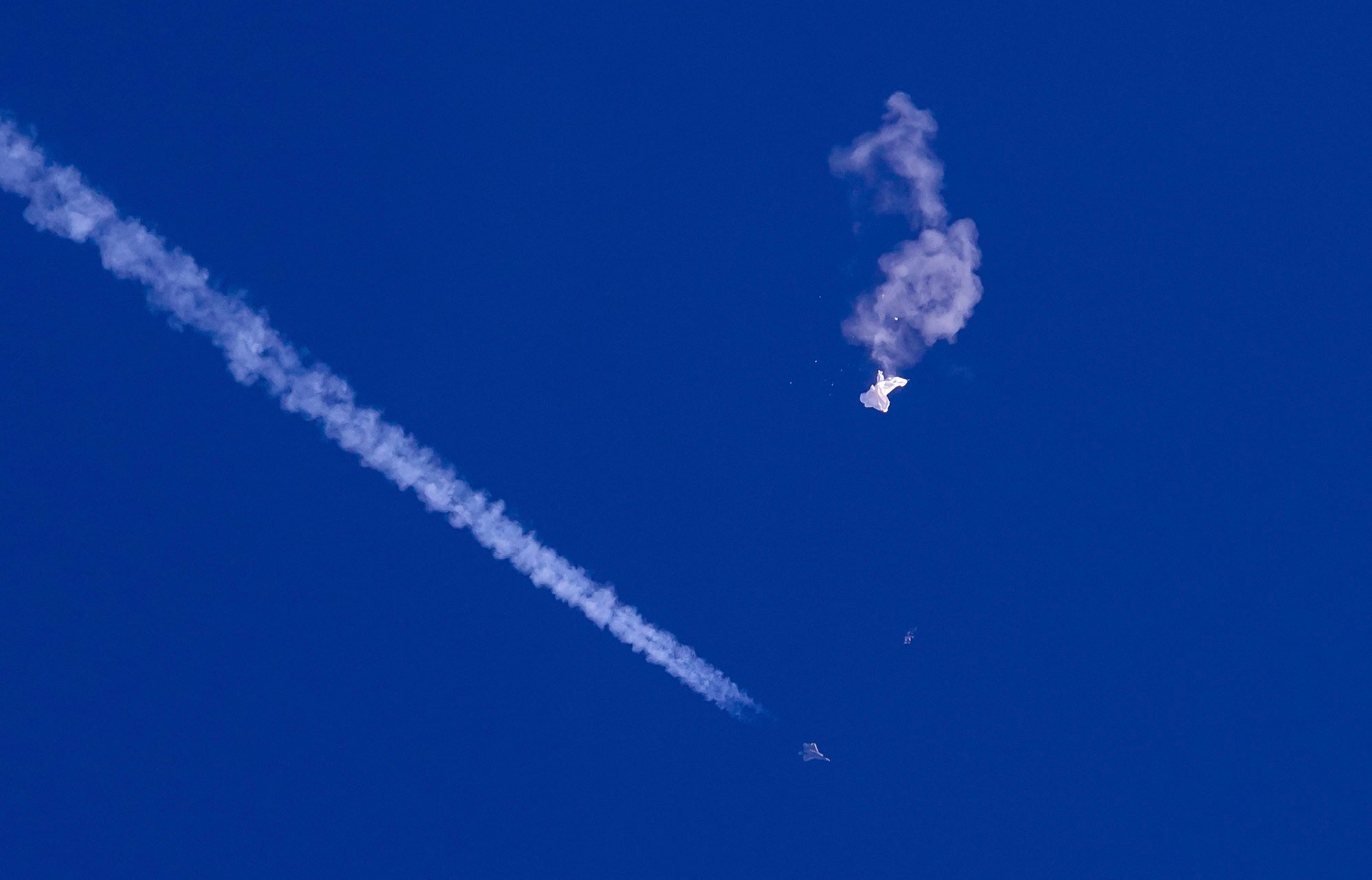 A fighter jet flies past the remnants of a large Chinese balloon after it was shot down above the Atlantic Ocean, just off the coast of South Carolina, on February 4, 2023. Photo: AP new speaker of the us house holds low profile but mainstream hawkish views on china 1