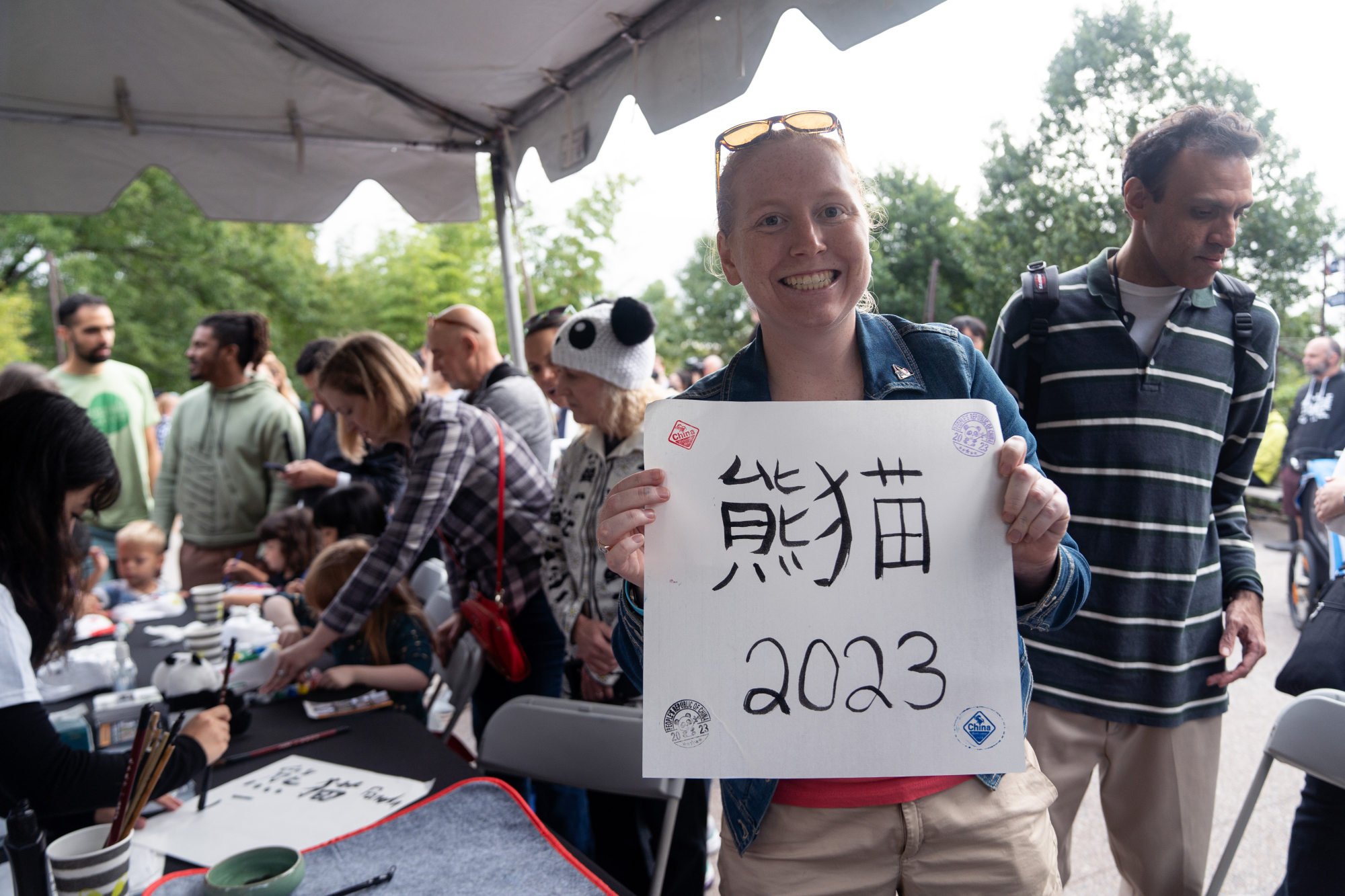 Visitors take part in a Chinese calligraphy writing activity at the Smithsonian’s National Zoo as part of farewell activities for giant pandas Mei Xiang, Tian Tian and Xiao Qi Ji which will be returned to China by the end of the year. Photo: Xinhua