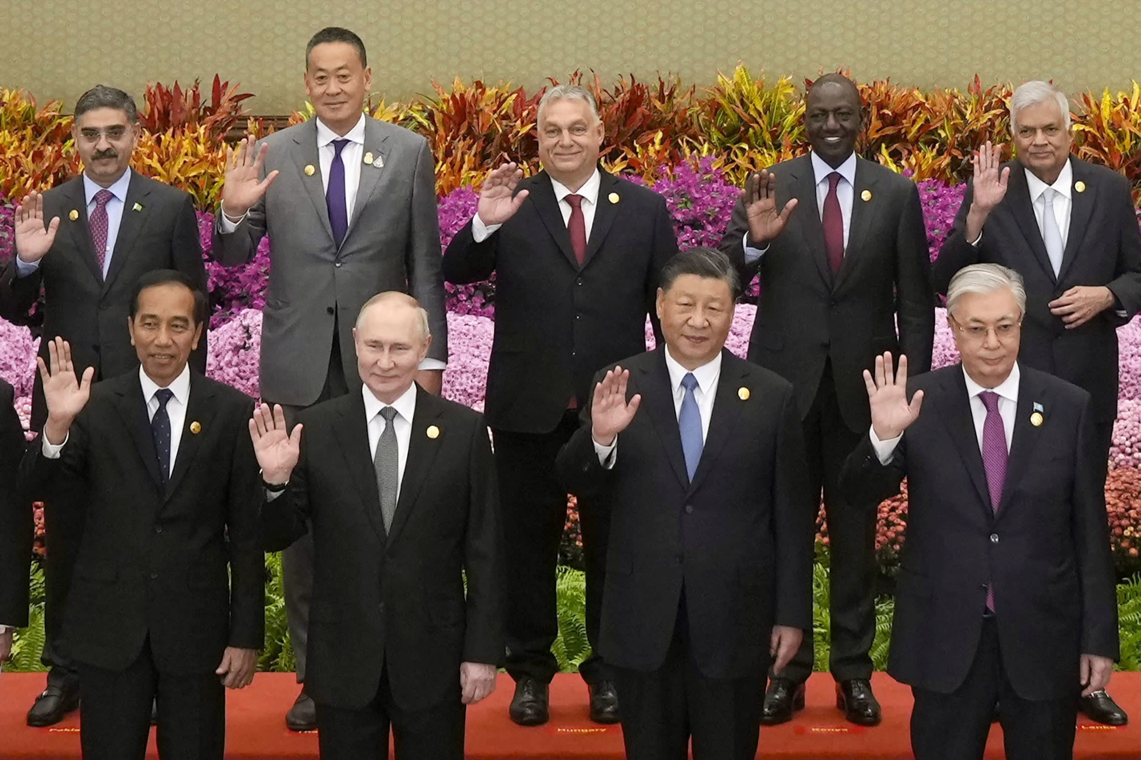 President Xi Jinping and President Vladimir Putin wave with other leaders as they take part in an international forum on China’s Belt and Road global initiative at the Great Hall of the People in Beijing last week