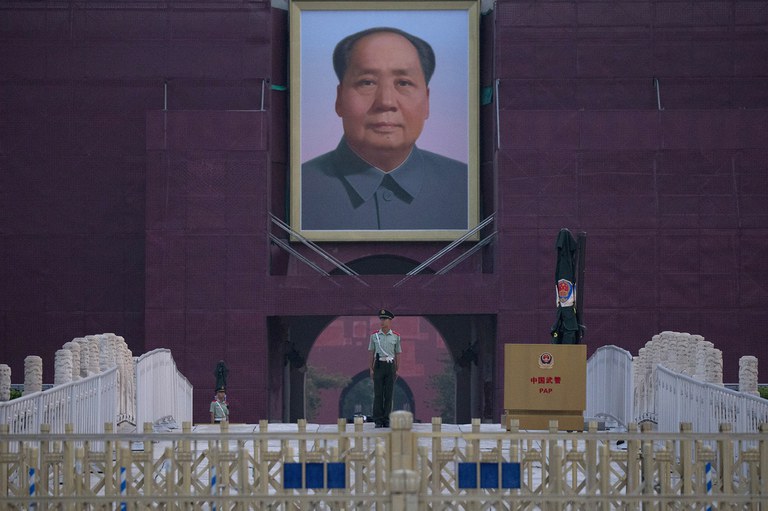 ENG_CHN_MassPolicing_11142023.4.jpg A Chinese paramilitary policeman stands guard in front of Mao Zedong's portrait on Tiananmen Gate, Credit: Ng Han Guan/AP