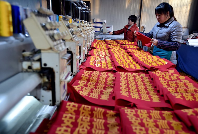 ENG_CHN_MassPolicing_11142023.2.JPG Workers make armbands reading "security patrol" at a garment factory in Zhangjiakou, Hebei province, China, Dec. 5, 2018. Credit: Reuters