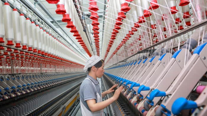 A worker operates machines at a texile factory in Nantong, in eastern China’s Jiangsu province