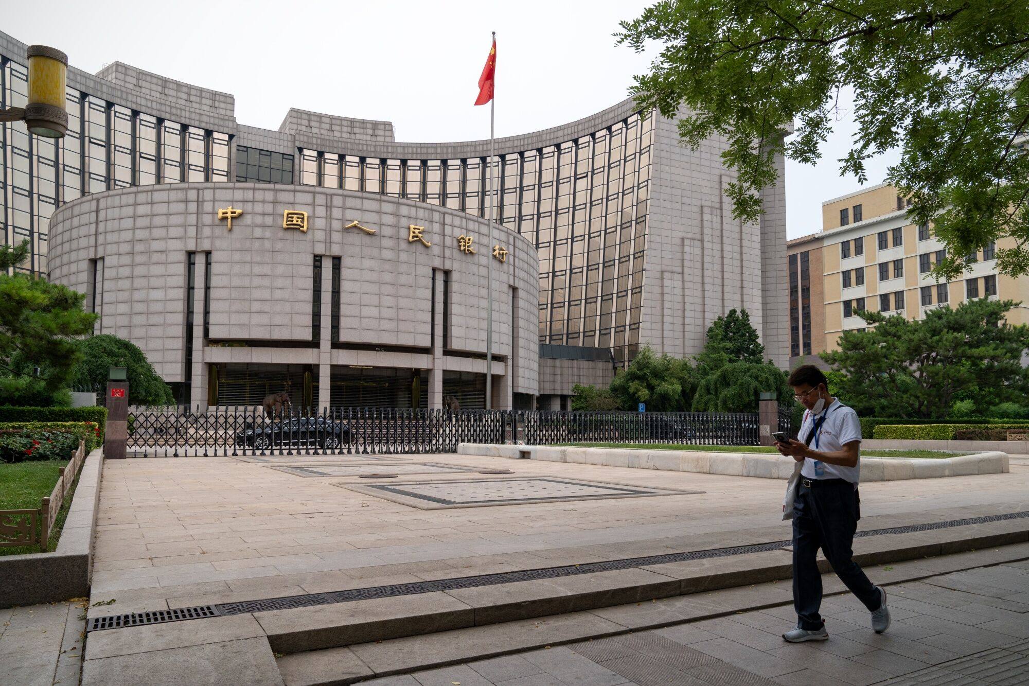 A man passes by the People’s Bank of China building in Beijing on June 26, 2023. Photo: Bloomberg