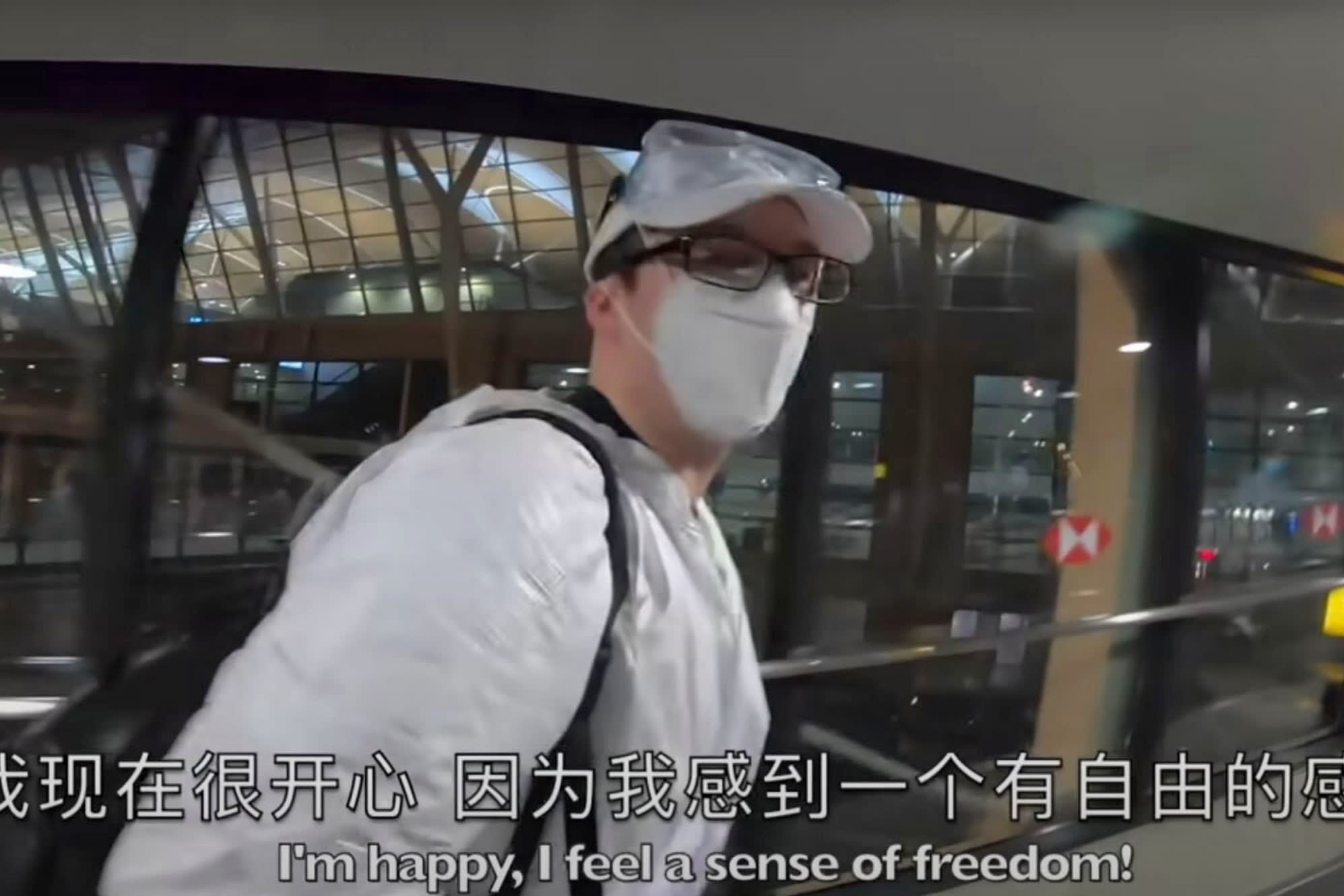 A screenshot of masked Kowal, with subtitles in English and Chinese reading: ‘I’m happy, I feel a sense of freedom!’