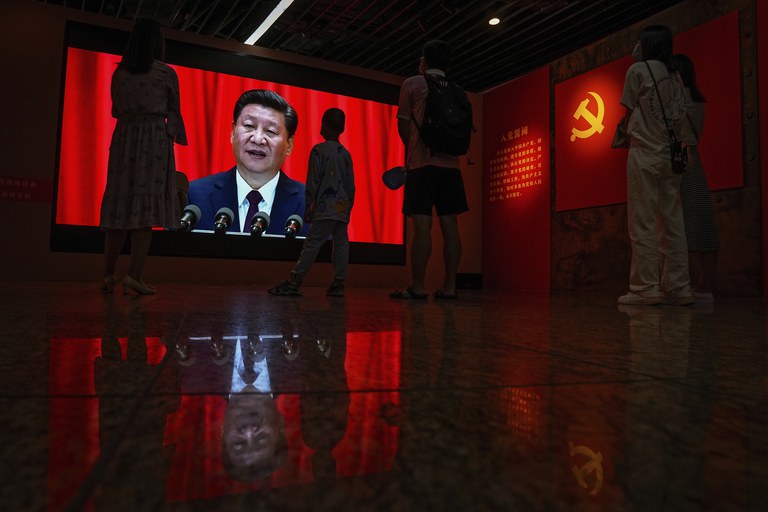 ENG_CHN_APECProtest_11142023_03.jpg Visitors watch a screen displaying Chinese President Xi Jinping’s speech next to a Communist Party's flag, at an exhibition promoting China's achievement under communist party from 1921 to 2021, in Beijing, June 20, 2021. Credit: Andy Wong/AP