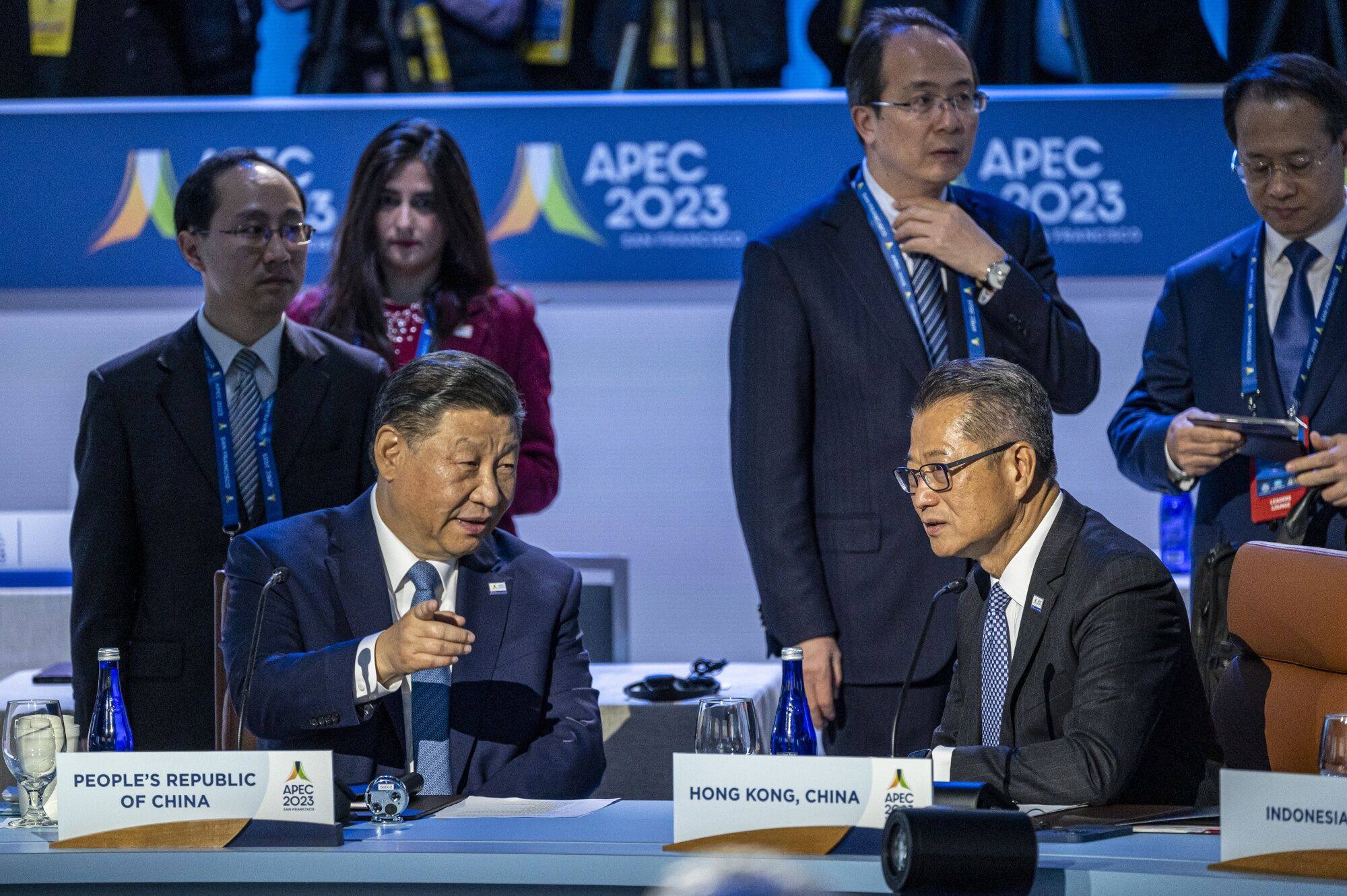 Chinese President Xi Jinping speaks with Hong Kong’s Paul Chan at the Apec forum. Photo: Bloomberg