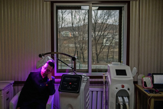 2_ENG_KOR_HairLossTreatment_11182023_03.jpg A man undergoes a hair-restoration procedure at the Sinuiju Cosmetics Factory in the North Korean border city of Sinuiju in 2018. Credit: Ed Jones/AFP