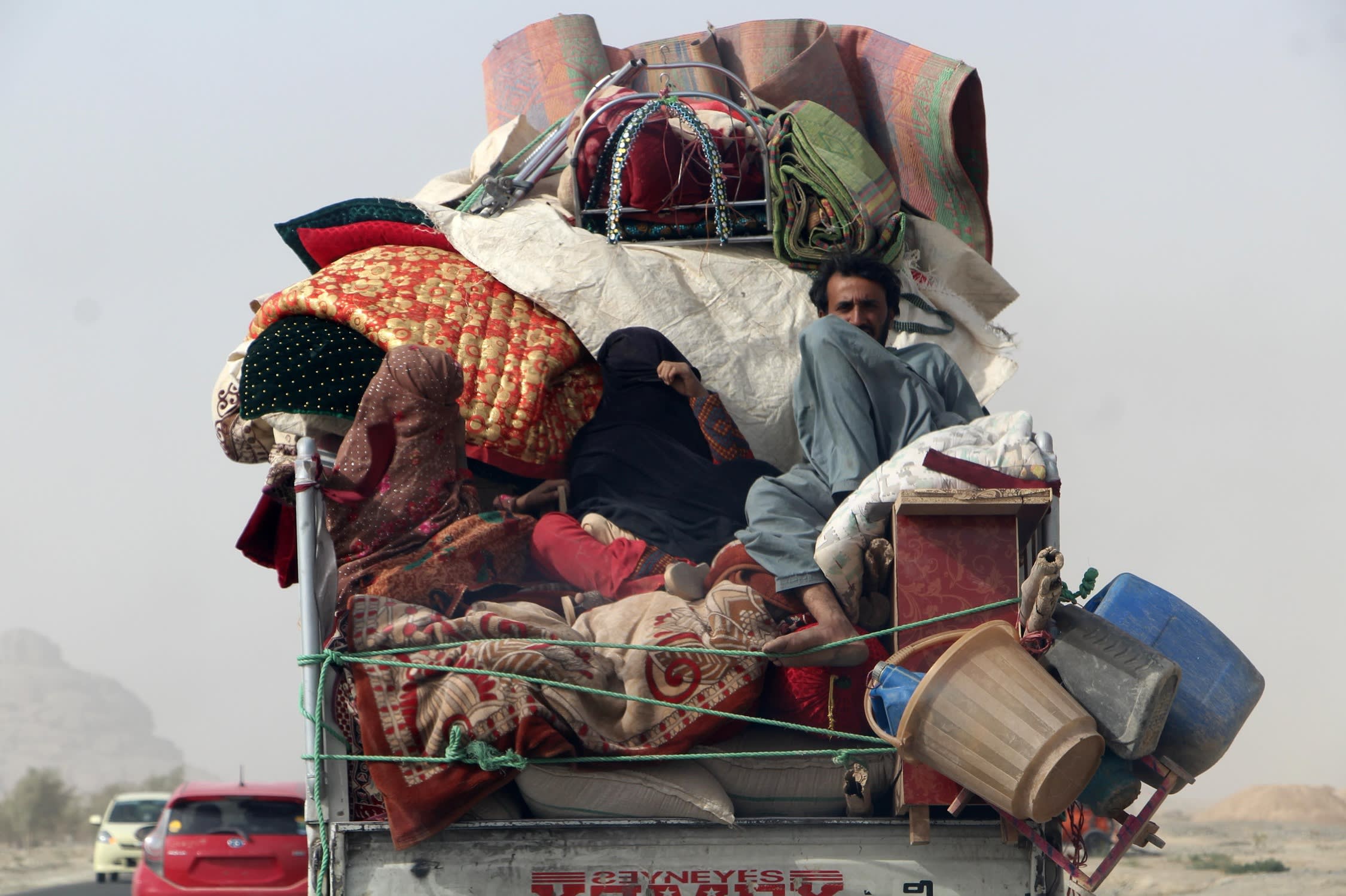 A truck loaded with possessions and several migrants arrives in Kandahar, Afghanistan