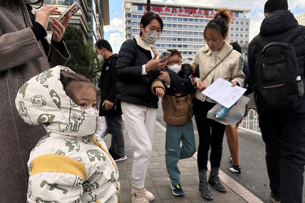 ENG_CHN_GuangdongPneumonia_11282023.2.jpg People and children leave a children's hospital in Beijing, China, Nov. 27, 2023. Credit: Tingshu Wang/Reuters