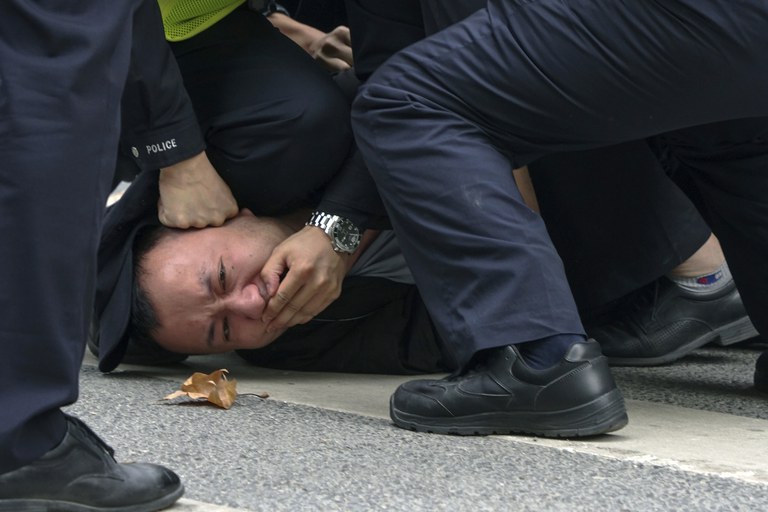 ENG_CHN_WhitePaperAnniversary_11252023.4.jpg Chinese police pin down and detain a protester during a protest against COVID-19 measures on a street in Shanghai, China on Nov. 27, 2022. Credit: AP