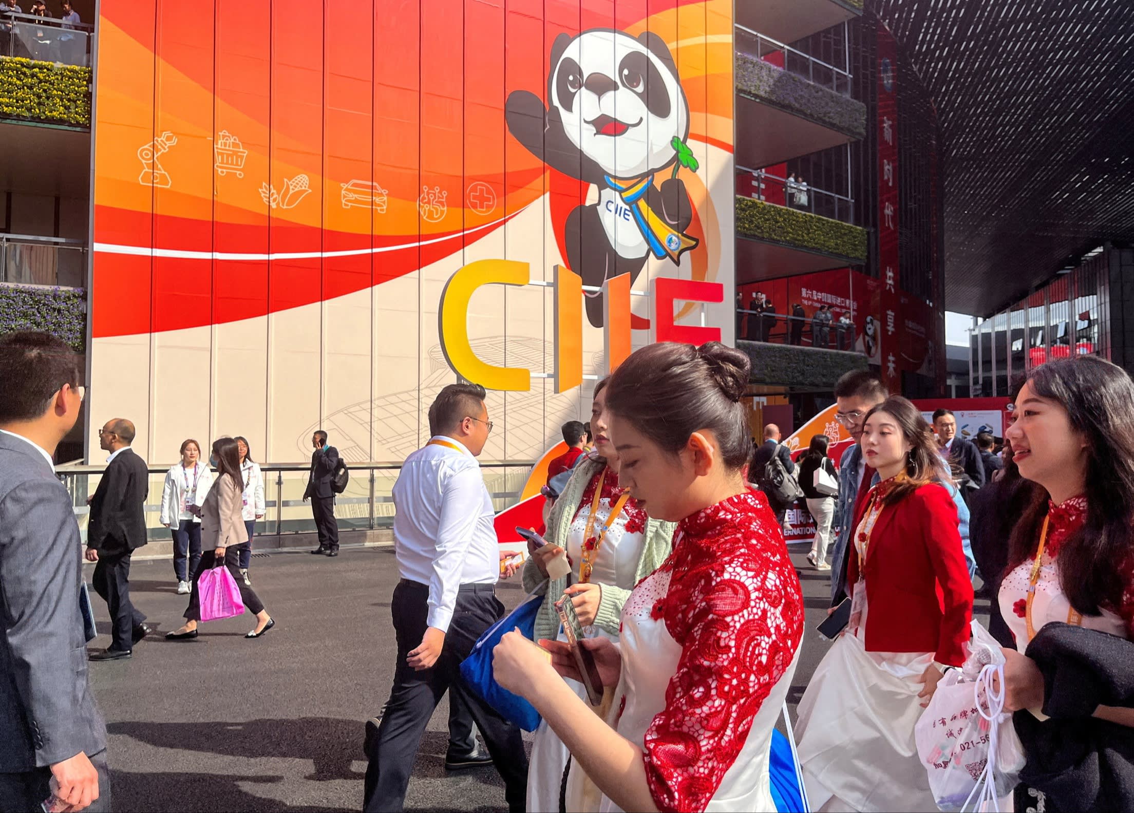 People walk past a huge CIIE banner outside the trade fair in Shanghai, China on November 6 2023