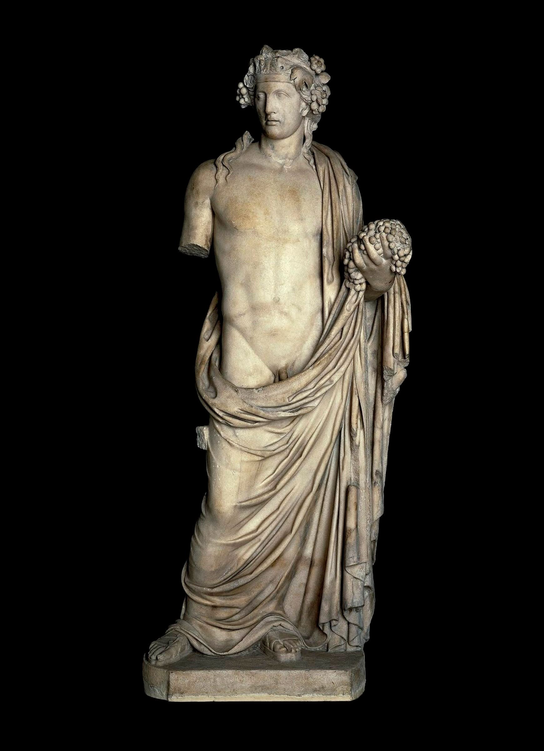 An ancient statue of Dionysus with one arm missing 