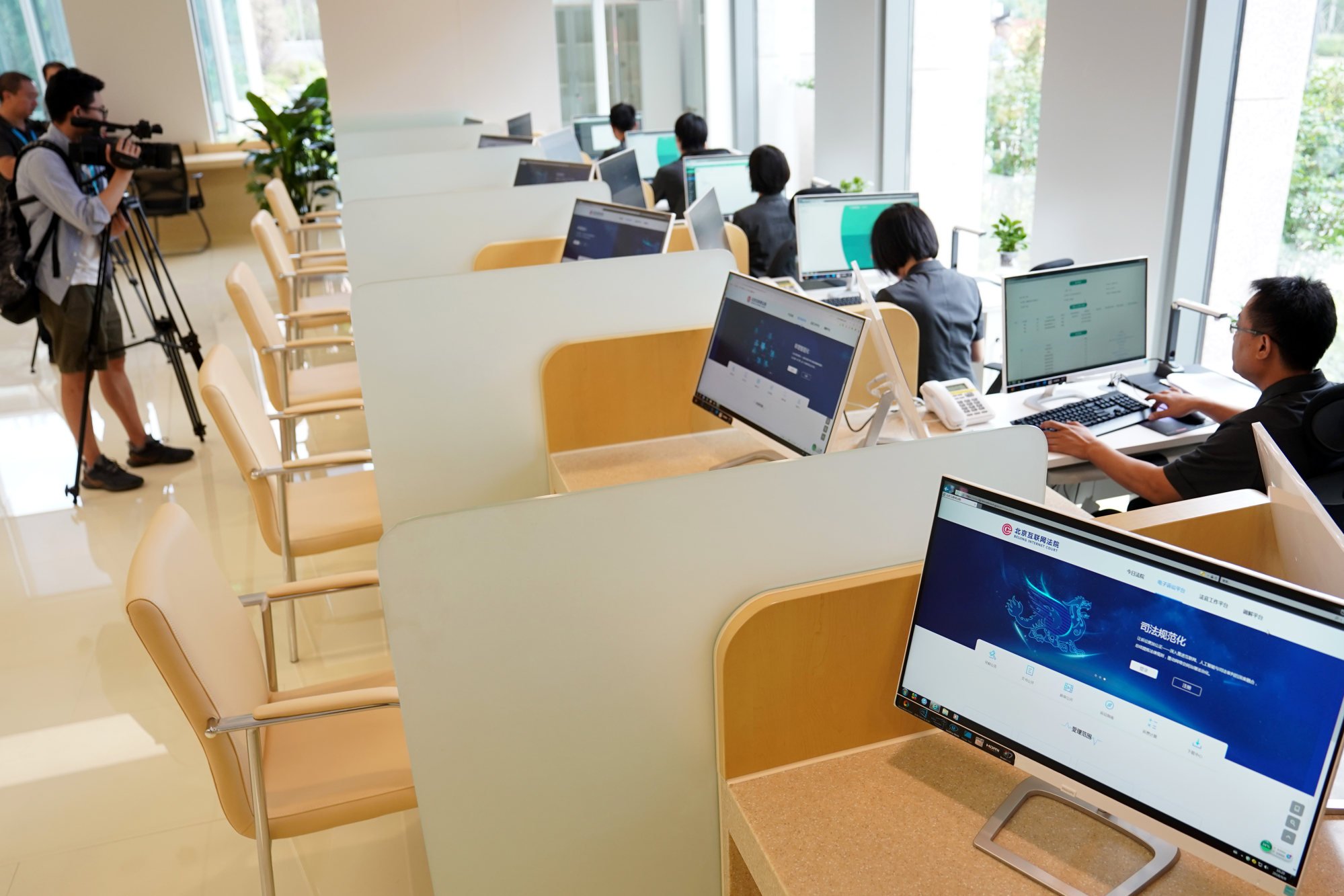 Staff members are seen working at the Beijing Internet Court when it opened on September 9, 2018. The court has jurisdiction over certain types of disputes in internet-related areas including copyrights, service contracts and online shopping. Photo: Xinhua