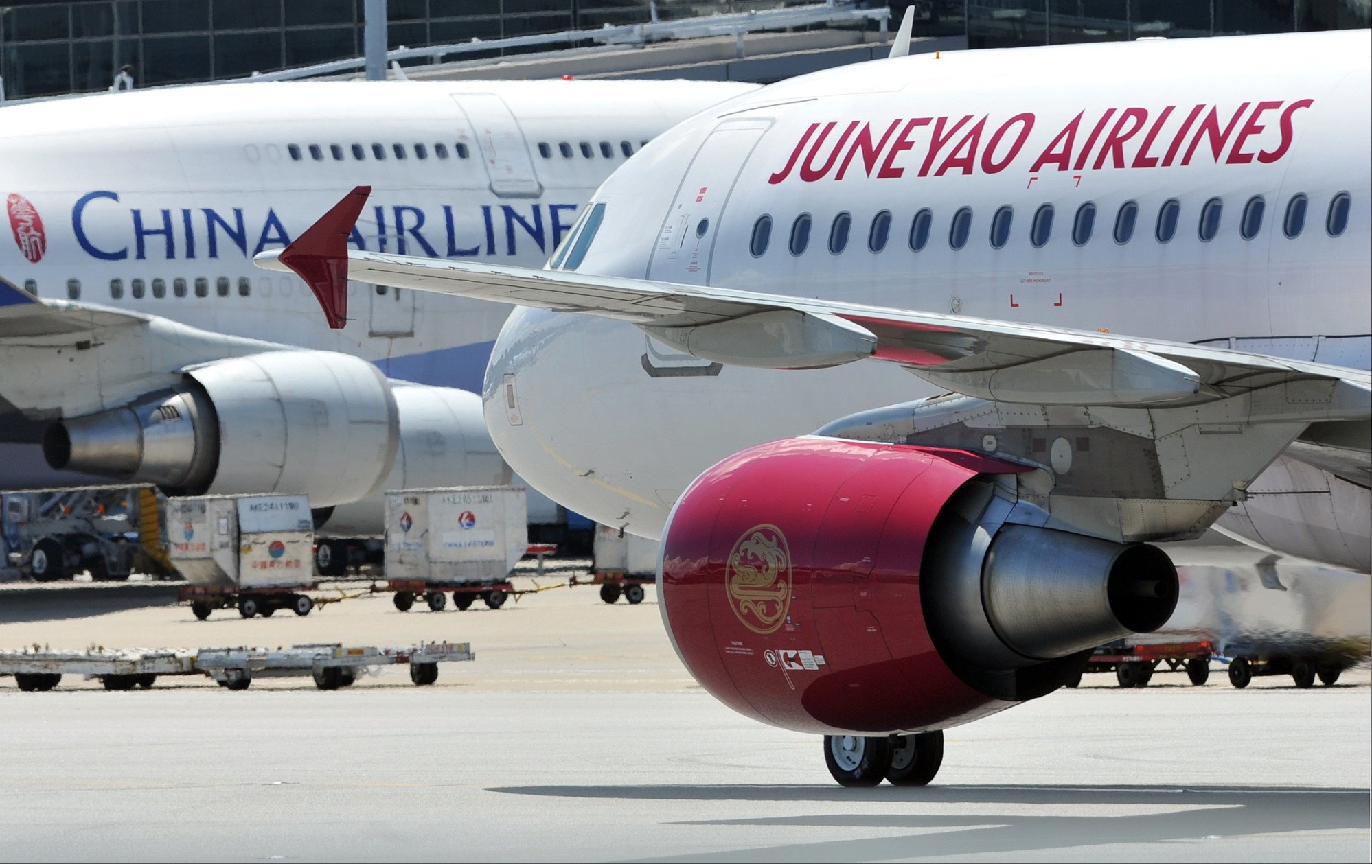 A Juneyao Airlines Airbus A320, right, and a China Airlines Boeing 747 at Hong Kong’s international airport. Photo: AFP