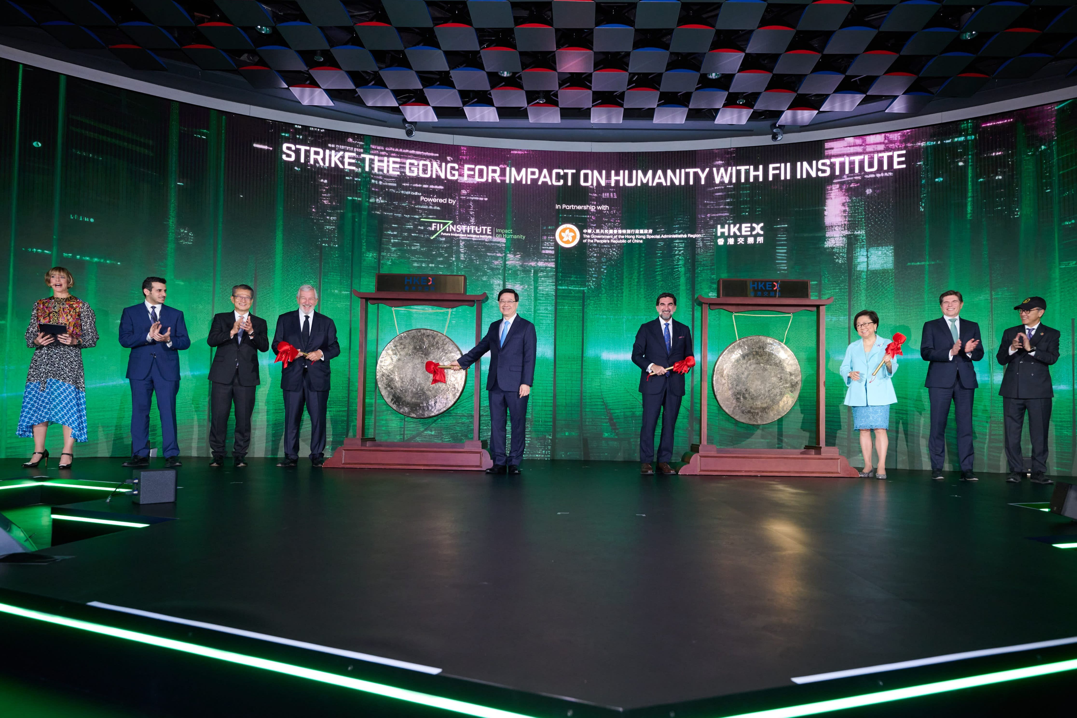 Hong Kong chief executive John Lee, centre left, strikes a gong opening the Future Investment Initiative Institute’s conference in Hong Kong on Thursday