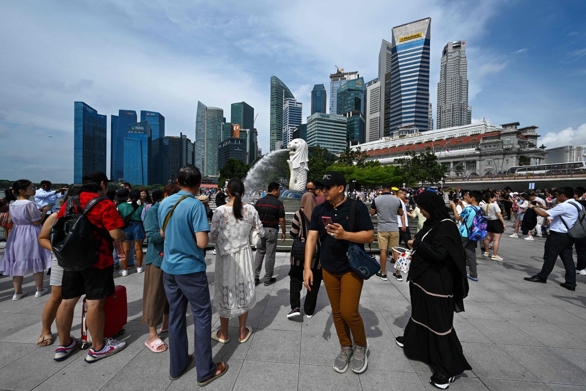 Tourists visit the Merlion Statue in Singapore. Photo: AFP
