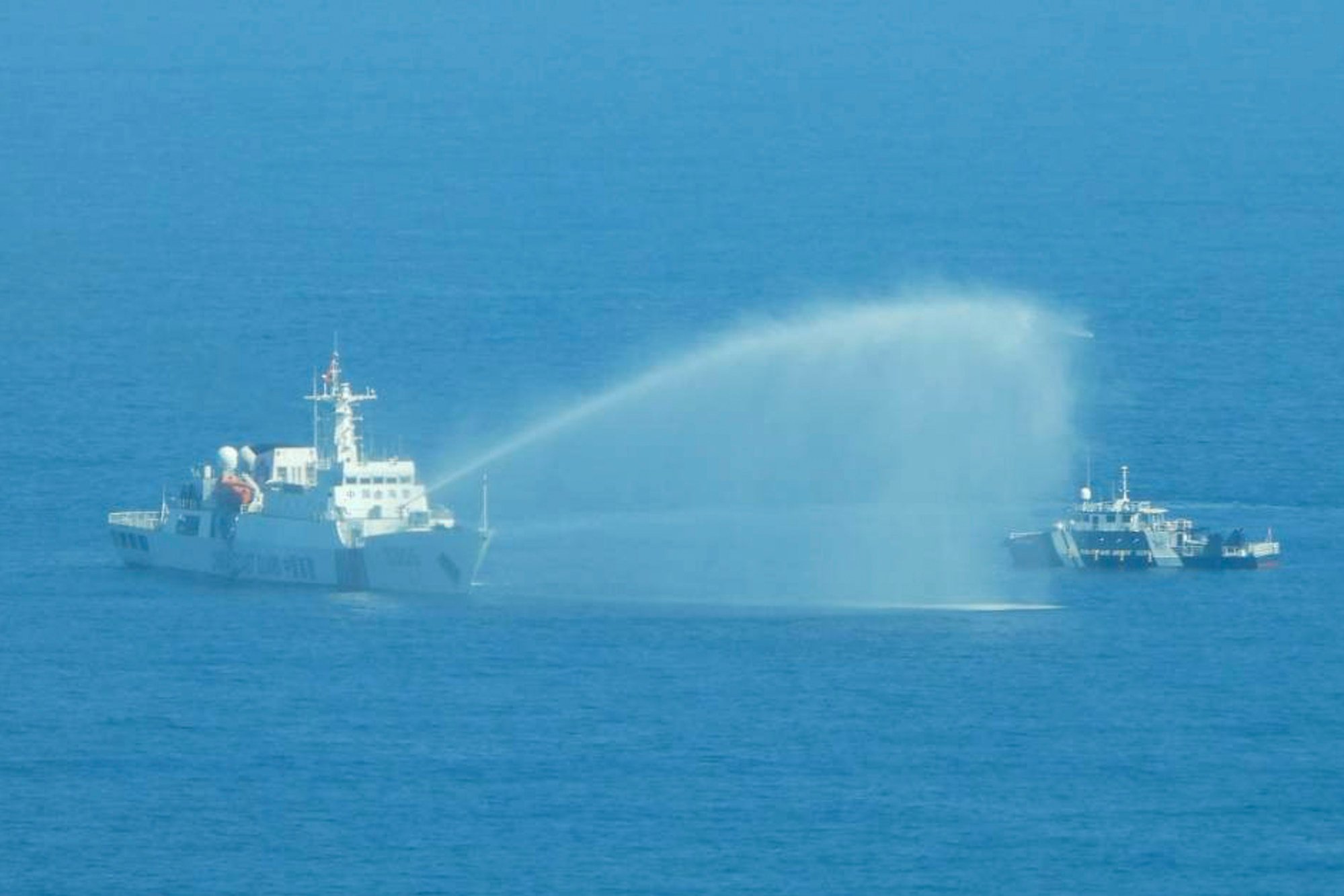 In this photo provided by Manila a Chinese coastguard ship (left) uses its water cannons on a Philippine Bureau of Fisheries and Aquatic Resources vessel in the disputed South China Sea. Photo: AP