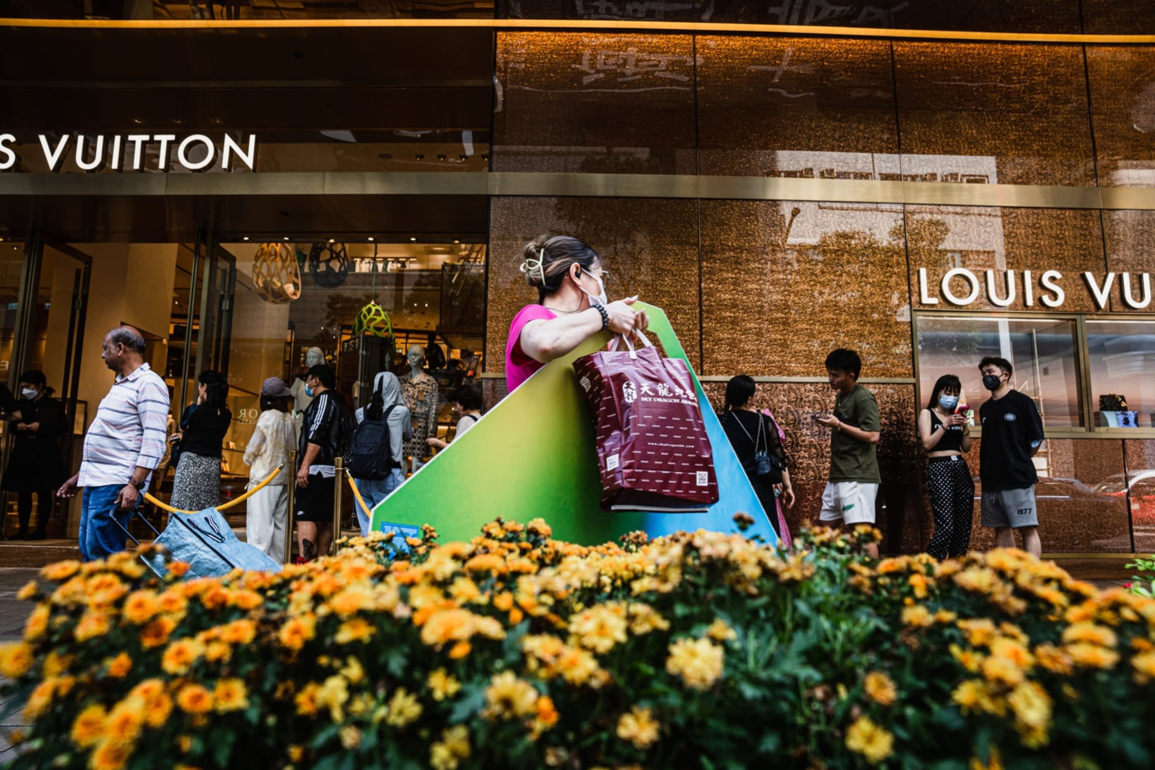Queues outside a LVHM Moet Hennessy Louis Vuitton SE store at Harbour City shopping mall in June