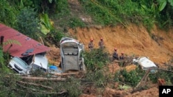 FILE - Rescue teams continue the search for victims caught in a landslide in Batang Kali, Malaysia, Dec. 17, 2022.
