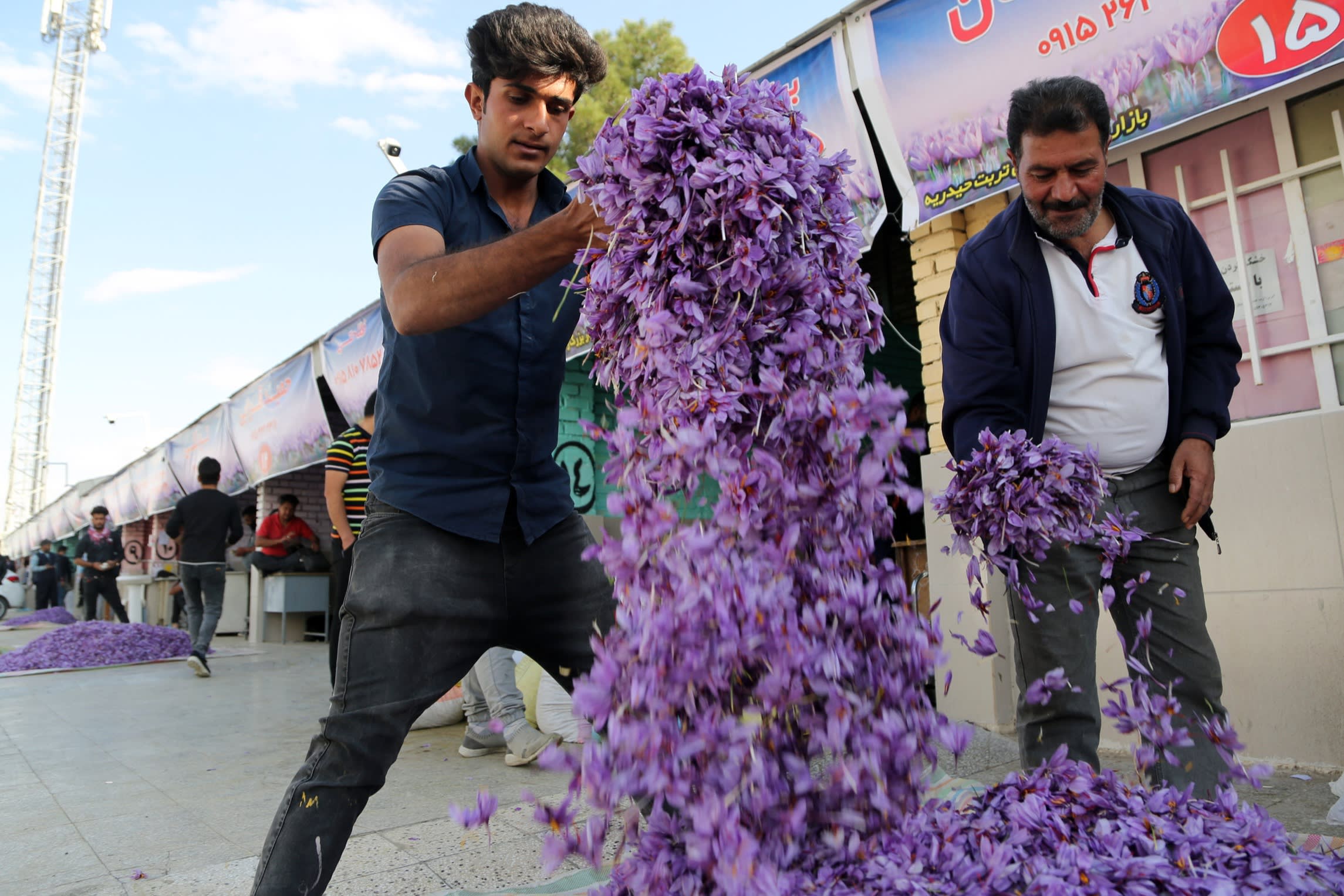 Traders sell saffron crocus flowers at a bazaar in Torbat Heydariyeh in north-east Iran