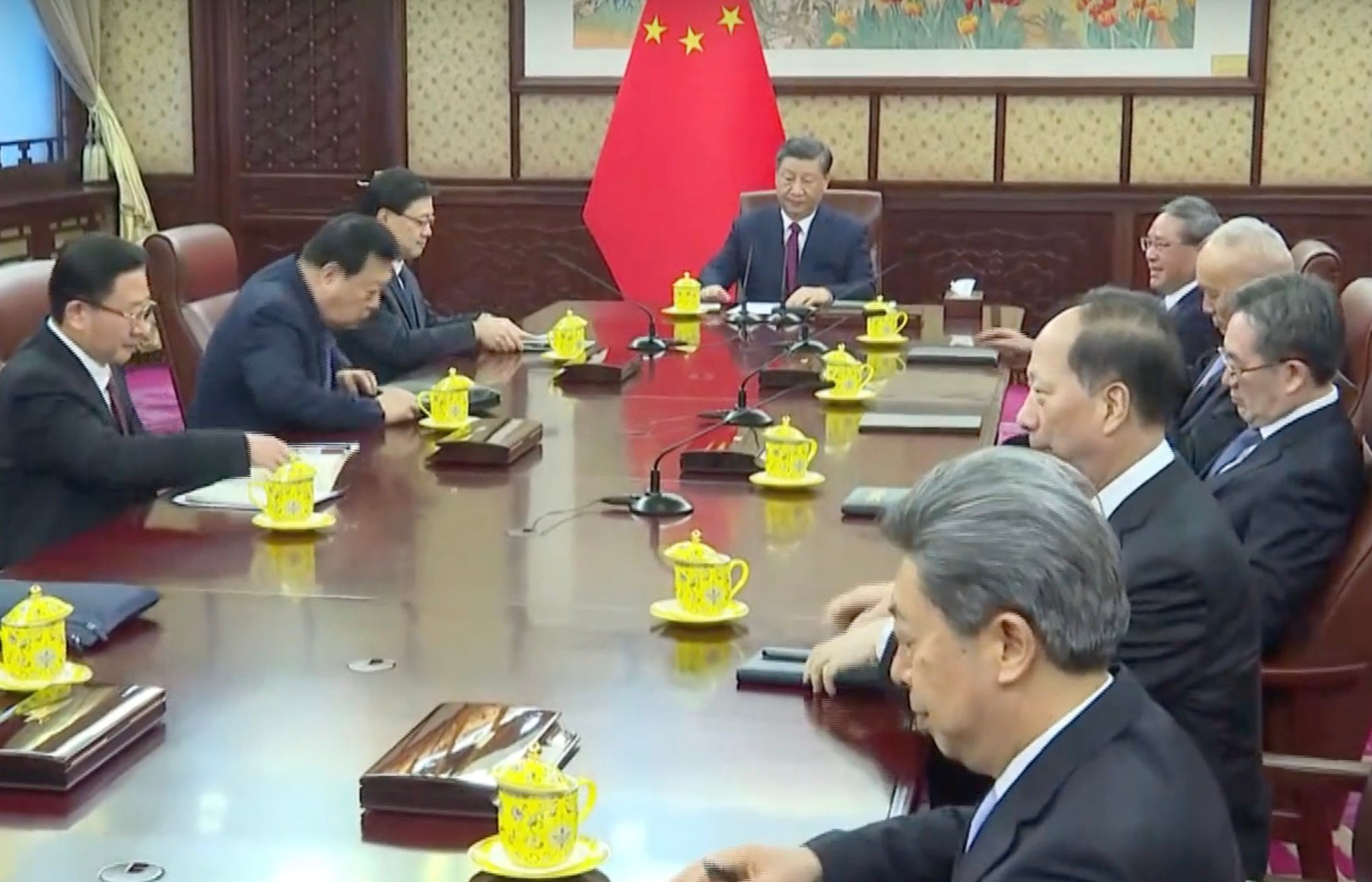 President Xi Jinping presides over Monday’s meeting with John Lee sitting to his right and Premier Li Qiang to his left. Photo: Pool