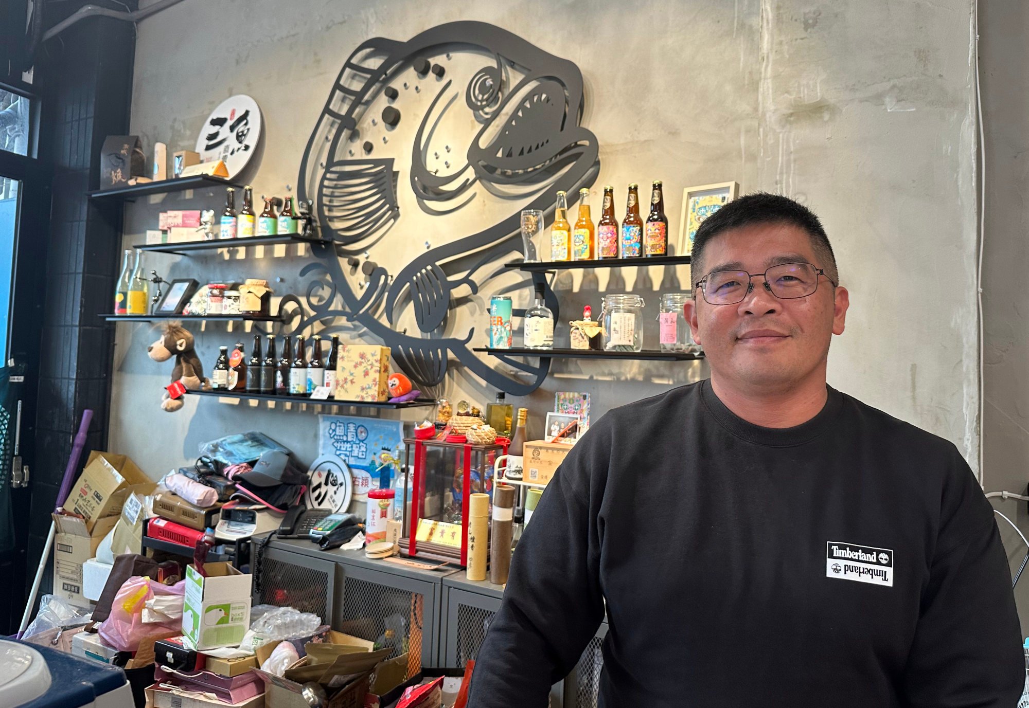 Apart from managing his fish farm, Chen Yu-ying has also been diversifying his business by opening a shop where he sells packaged products like frozen fish and pet snacks to tourists to Pingtung. Photo: Kinling Lo