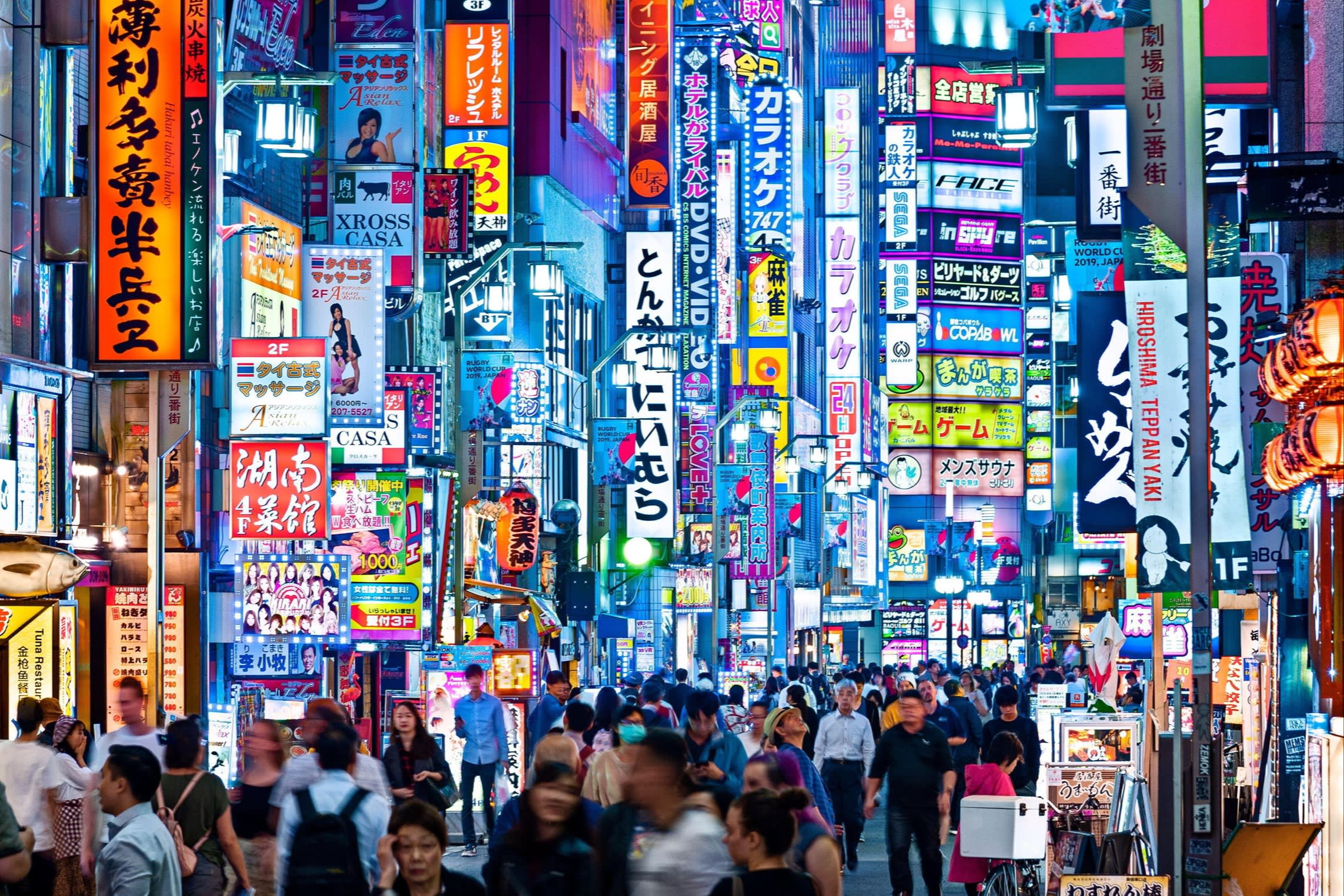 crowded tokyo street at night with neon lights